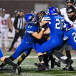 Brendan Barry (24) makes a tackle as Luke Olsen (20) and Johnny OBrien (26) join in on the action. Photo courtesy of Greg Nelson
