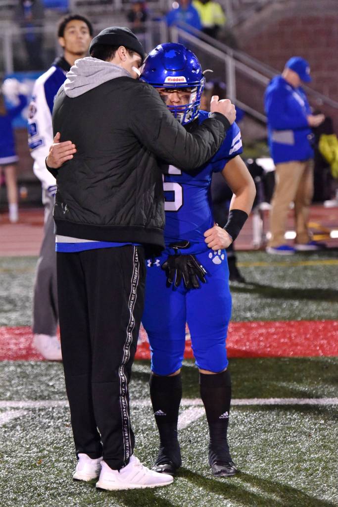 Christian Galvan receives consolation following the state championship game. Photo courtesy of Greg Nelson