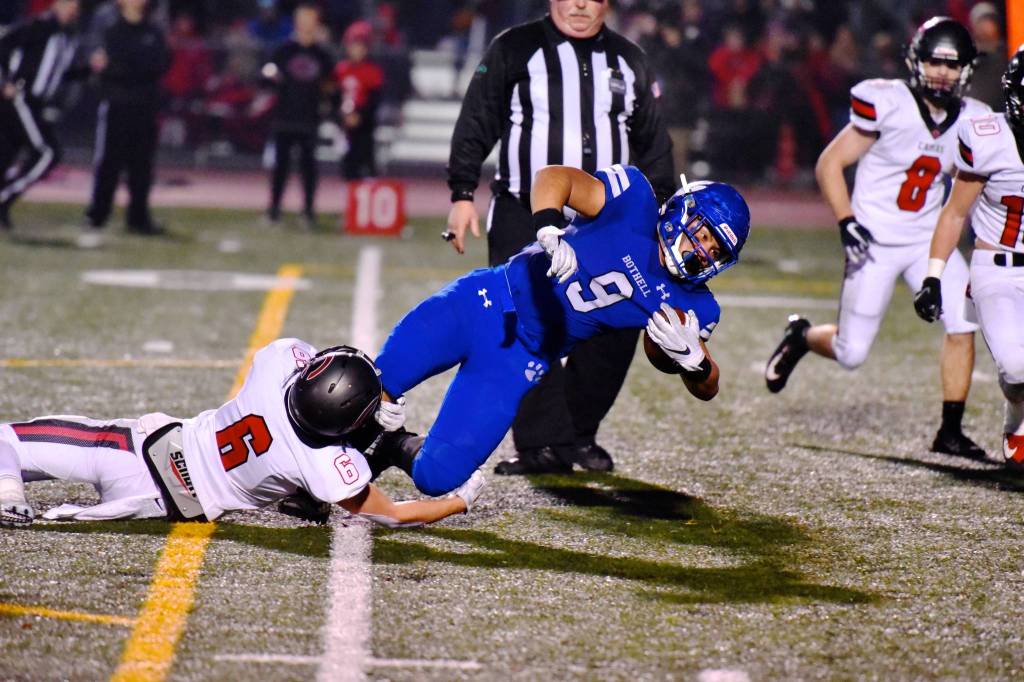 Tala Tevaga lunges for some extra yardage as Camas Dante Humble grabs on for the ride. Photo courtesy of Greg Nelson