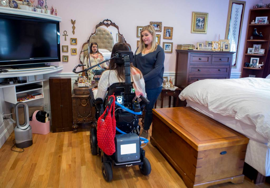Lindsey Holland, a nurse, talks with Loa Griesbach about what makeup she wants. (Olivia Vanni / Everett Herald)