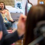 Lindsey Holland, a nurse, puts eye shadow on Loa Griesbach. (Olivia Vanni / Everett Herald)