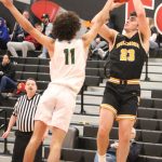 Inglemoor forward Peter Hansen (right) takes a shot over Redmond forward Jahi Coleman. The Vikings defeated the Mustangs, 63-57, in a KingCo 4A league tournament game on Jan. 8. Benjamin Olson/staff photo