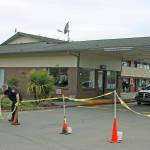 A security guard positions cones as he stands watch in front of the Econo Lodge-turned-coronavirus-quarantine site on Central Avenue North on Tuesday. King County personnel were on site preparing the motels transformation into an isolation/quarantine center. MARK KLAAS, Kent Reporter