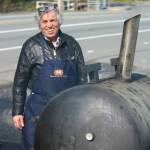 Butcher Shop Cafe owner Mohamed Souaiaia checks on the smoker outside of his establishment in Kenmore. Andy Nystrom/staff photo
