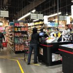 A cashier at H Mart in Bellevue rings up a customer on March 28. Samantha Pak/staff photo
