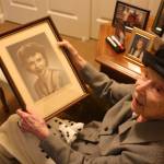 Gladys Mills Pennington looks at a picture of her younger self (photo by Cameron Sheppard)