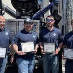 Brian Taylor, Christian Melton, Haakon Lande and Ryan Helvey smile with certificates. Courtesy of NUD.