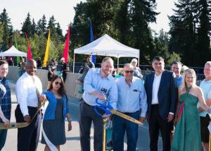 Mayor Nigel Herbig smiles as he cuts the ribbon at the West Sammamish River Bridge grand opening celebration on August 11. Courtesy of the City of Kenmore.