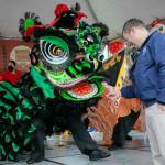 Edmonds Mayor Mike Nelson rewards a lion dancer with a traditional red envelope during a celebration of the Lunar New Year on Saturday, Jan. 21, 2023. Photo by Ryan Berry / The Herald