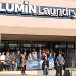 Lumin Laundry owners and staff gathered with the Edmonds Chamber of Commerce for the ribbon cutting at their grand opening. Photo courtesy Lumin Laundry.