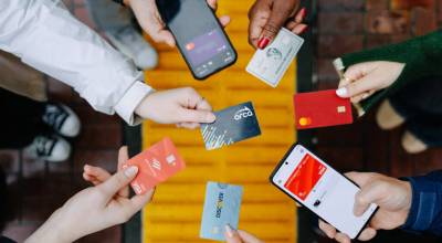 Passengers demonstrate open payments with credit cards and phones to pay transit fares on the ORCA system. COURTESY PHOTO, ORCA