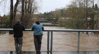 Onlookers observe high flood levels outside Renton Library, December 2025. Photo by Bailey Jo Josie/Sound Publishing.